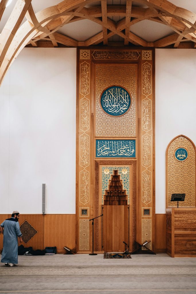 Warm timber architecture and mihrab inside Cambridge Central Mosque